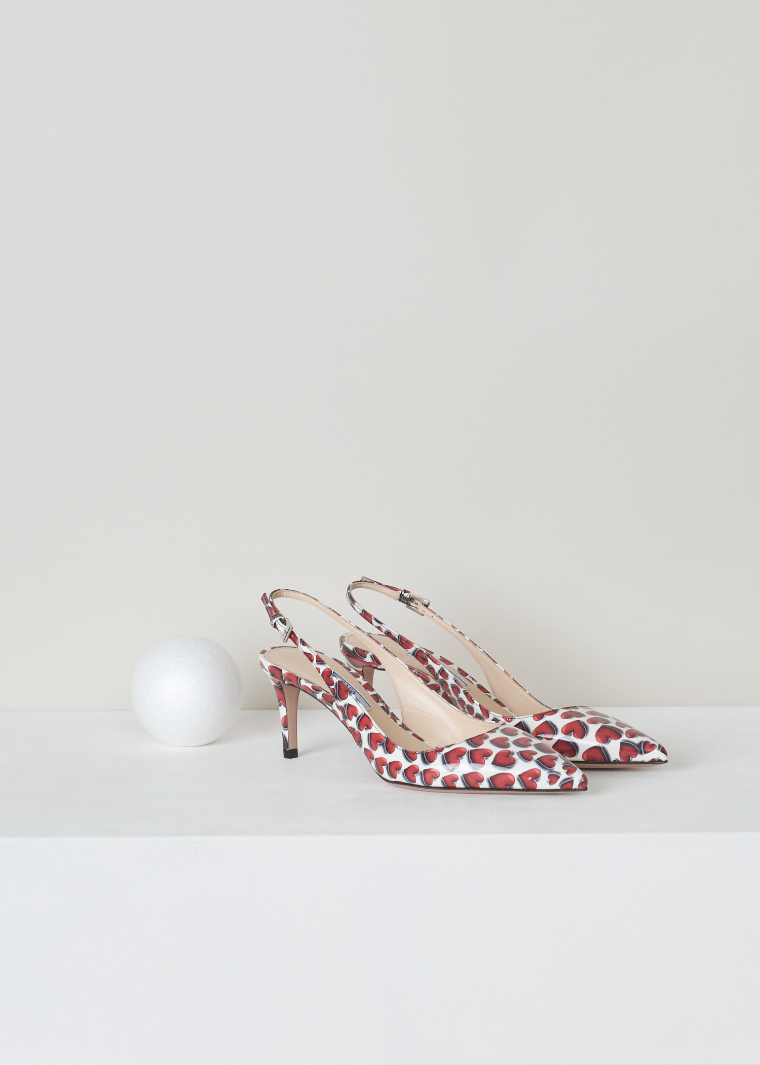 Prada, Red and white patent leather heart print, vernice_cuori_1I833I_F0D56_scarlatto, red white, front, Red and white heart printed slingback. Pointed toe and mid high stiletto heel. With a gold-tone logo plaque on the sole.
