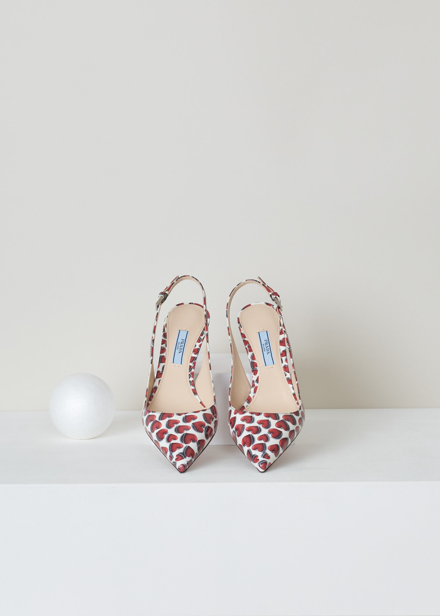 Prada, Red and white patent leather heart print, vernice_cuori_1I833I_F0D56_scarlatto, red white, top, Red and white heart printed slingback. Pointed toe and mid high stiletto heel. With a gold-tone logo plaque on the sole.