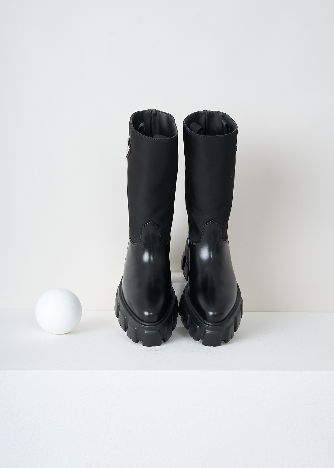 Prada, Black Re-nylon ankle boots, 
3LFU_SPAZZOLATO_NYLON_1U713M_F0002_NENO, Black, Top, These slip-on ankle boots have a Re-Nylon shaft and a high-shine leather vamp and heel. On the shaft, the brand's signature triangle logo can be found. These boots have chunky rubber track soles.
