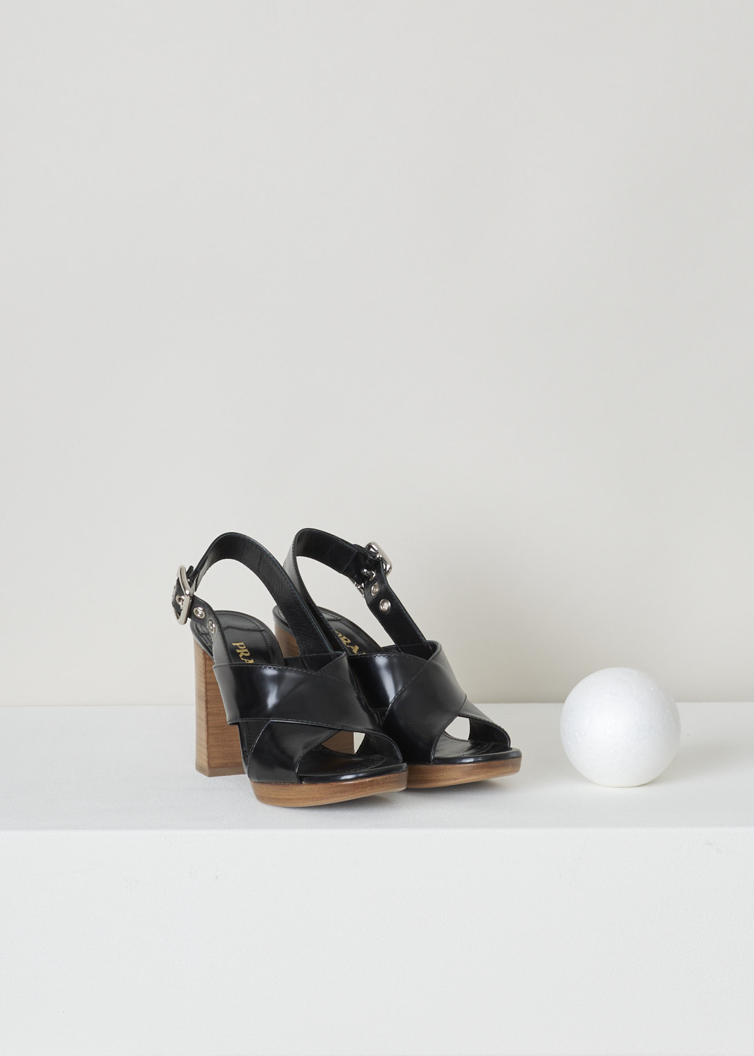Prada, Black cross-strap slingback, spazzolato_1X543F_nero_F0002, black brown, front, Black platform slingbacks, comes with a cross toe strap, and a silver-tone buckle as your fastening option. The chunky heel and platform, are both coloured brown. 

Heel height: 9 cm / 3.54 inch. 
