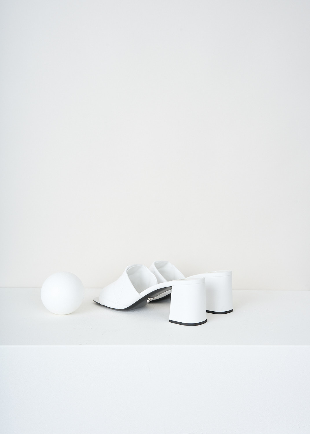 Prada, White matelassé mules, 038_NAPPA_1XX583_F0009_BIANCO, White, Back, These white open-toe mules have a broad matelassé strap across the vamp. These mules have a blocked heel.


