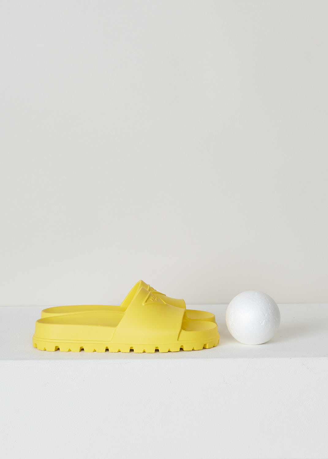 PRADA, YELLOW SLIDES, 1XX626_3LKV_F0377_3_99_F_020_CALZATURE_DONNA_SOLE, Yellow, Side, These yellow slip-on style slides have a round open toe with an embossed logo on the front. These slides have ridged soles. 