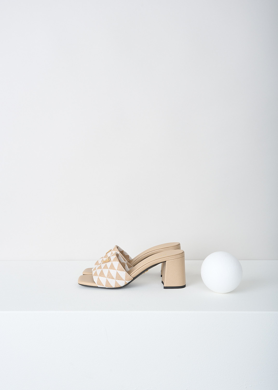 Prada, Beige-and-white triangolo mules, 3LK6_TRIANGOLO_JACQUARD_1XX637_F0J0A_CORDA_TALCO_065, Beige, White, Print, Side, These slip-on mules have a broad strap with a beige-and-white triangolo jacquard print. On the strap, the brand's triangle logo can be found in gold-tone metal. 
