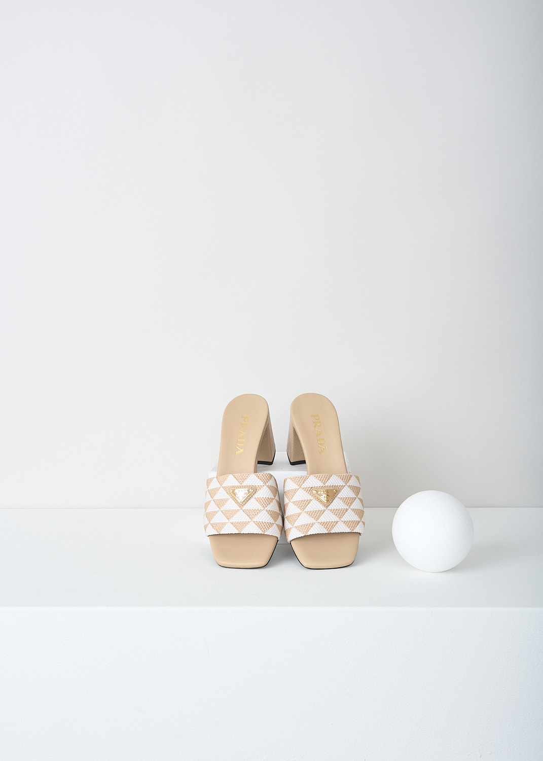 Prada, Beige-and-white triangolo mules, 3LK6_TRIANGOLO_JACQUARD_1XX637_F0J0A_CORDA_TALCO_065, Beigem, White, Print, Top, These slip-on mules have a broad strap with a beige-and-white triangolo jacquard print. On the strap, the brand's triangle logo can be found in gold-tone metal. 
