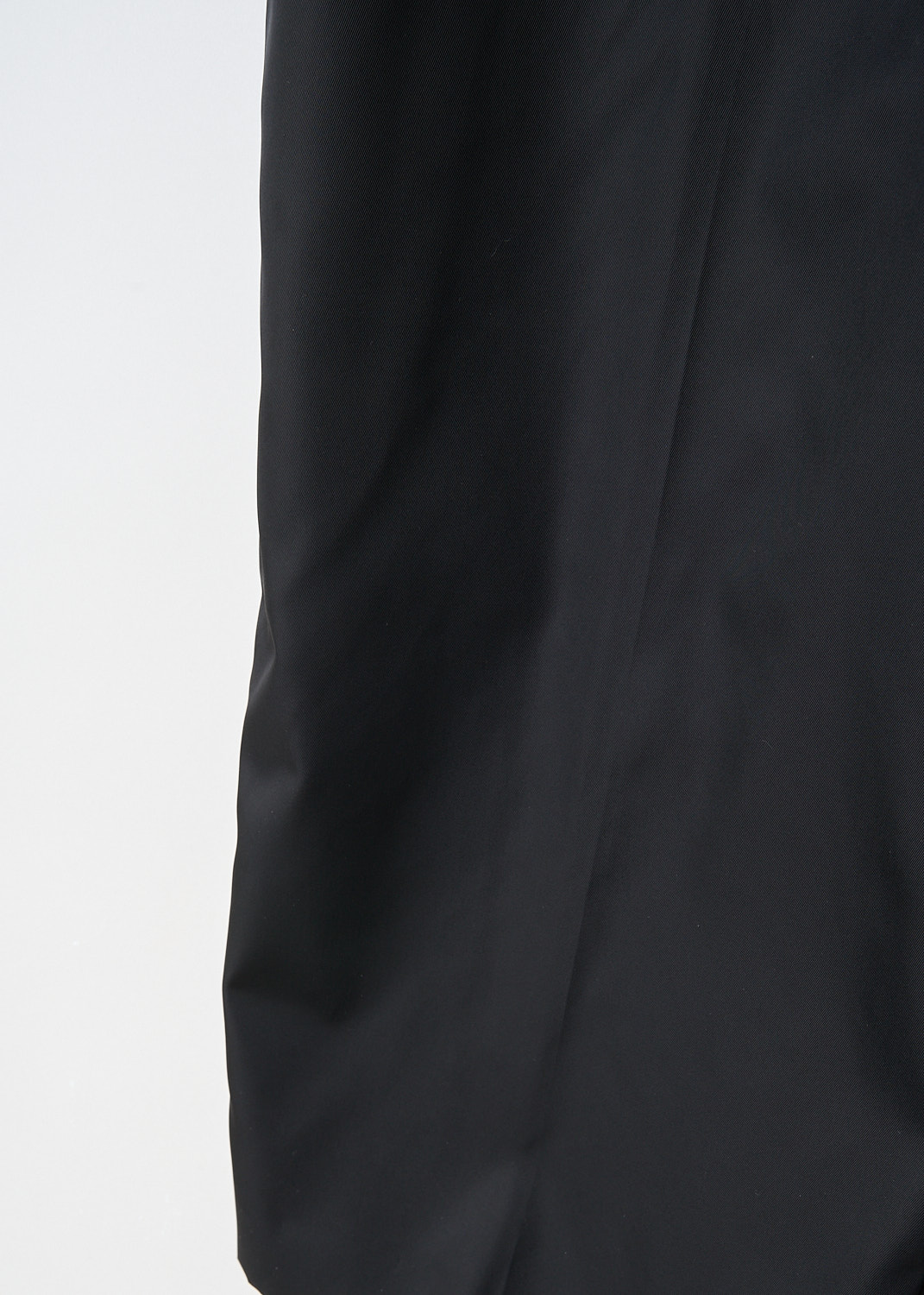 Close-up of waistband with belt loops on black Prada wide-leg trousers at Kiki's Stocksale designer outlet boutique in Maastricht.