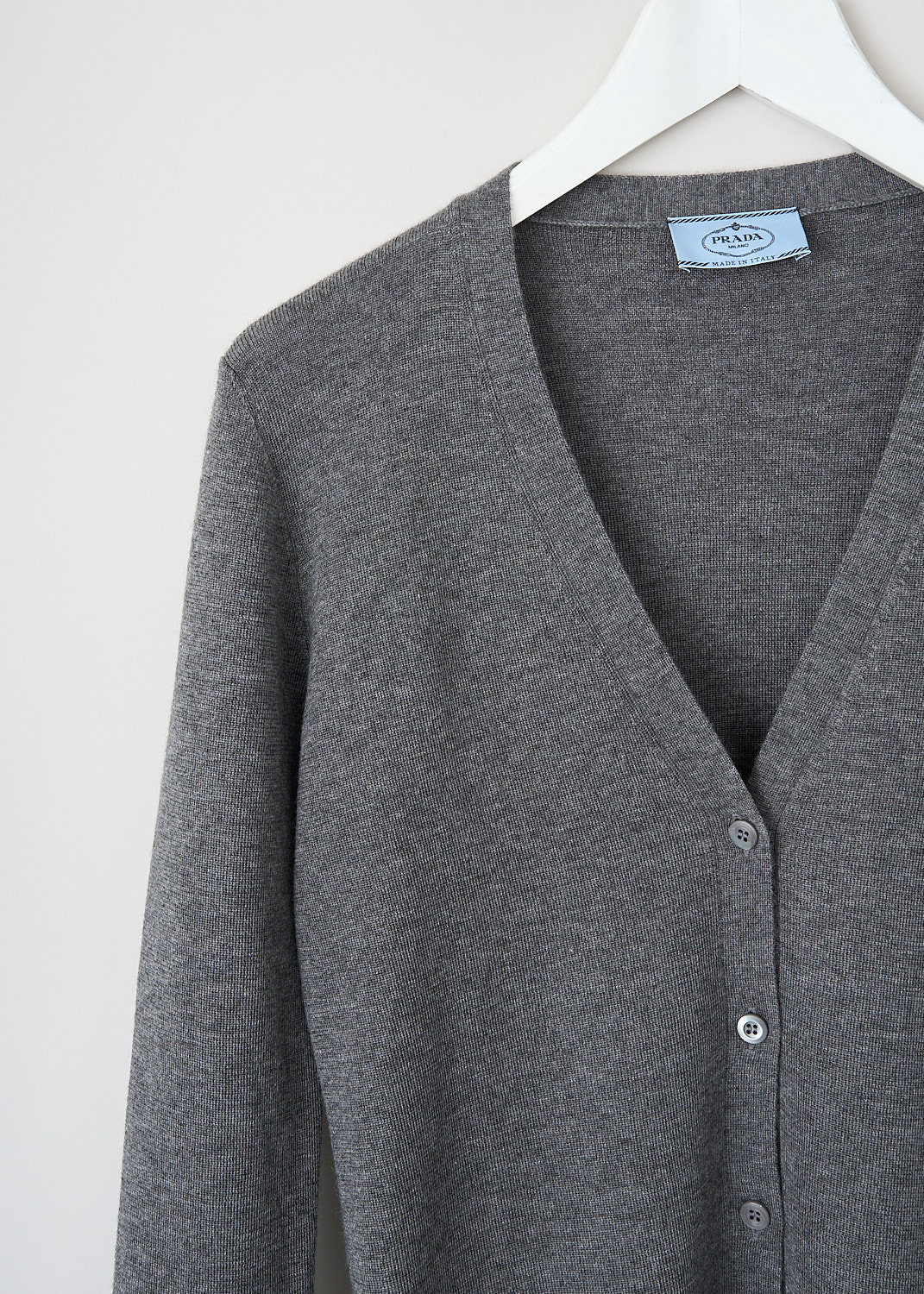 Prada, Grey cashmere cardigan, 25437_40J_F0031_GRIGIO, Grey, Detail, This grey cashmere cardigan has a V-neckline and a front button closure. The long sleeves have straight hems. 
