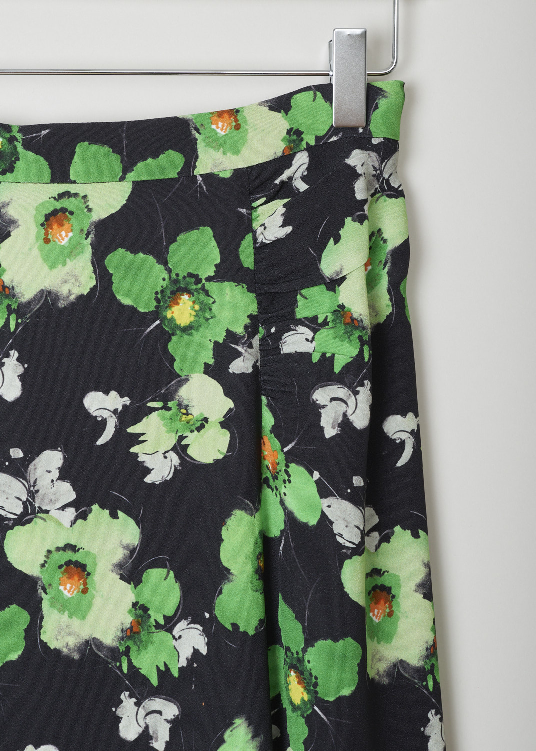 Prada, Black semi-circular skirt with green floral motif, sable_raso_narc_P152S_F077U_smeraldo, print, detail, Starting from the top this mid-length skirt comes with a narrow waistband, with the fastening option being on the left side. The seams coming of the waistband are ruched and adds more excitement to this model. Furthermore, this model does flare out, and has a short split on the back.