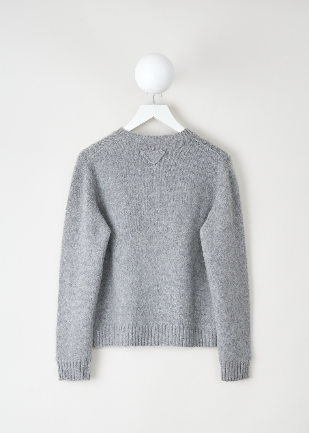 Back view of light grey Prada cardigan with ribbed hem and cuffs at Kiki's Stocksale luxury designer outlet Maastricht.