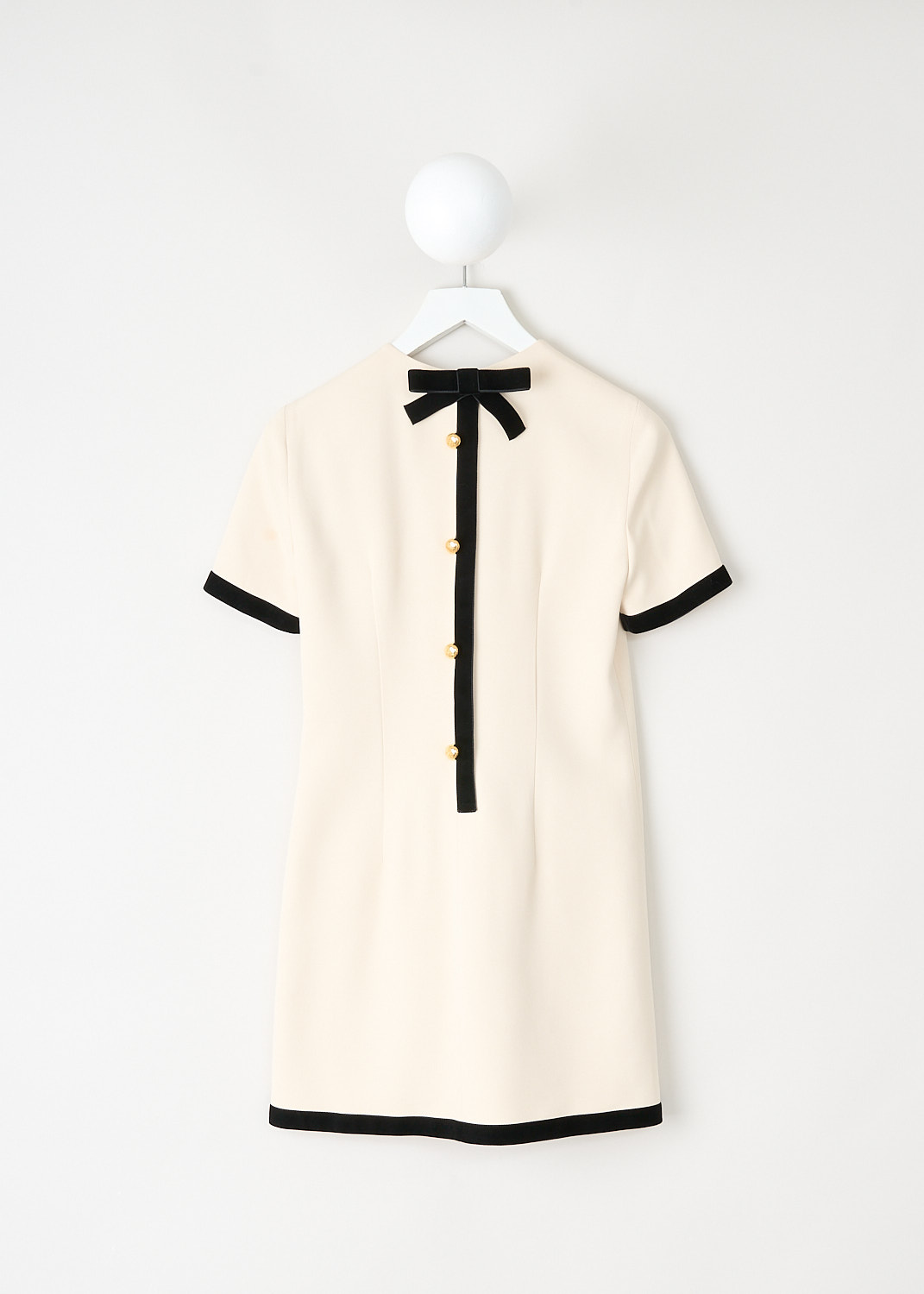 Back view of the off-white A-line mini dress with concealed velvet-trimmed closure and gold-tone buttons by Prada, available at designer boutique Kiki's Stocksale in Maastricht.