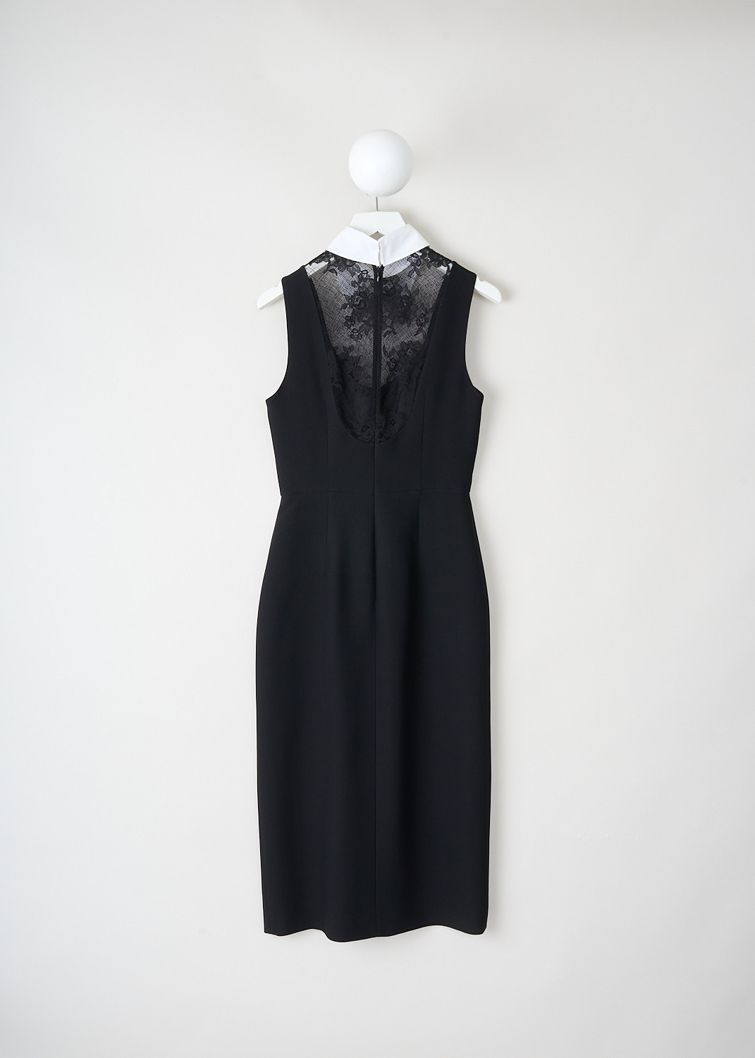 Close-up of black viscose fabric and lace combination on Prada maxi dress, showing layered luxury materials and fine tailoring.