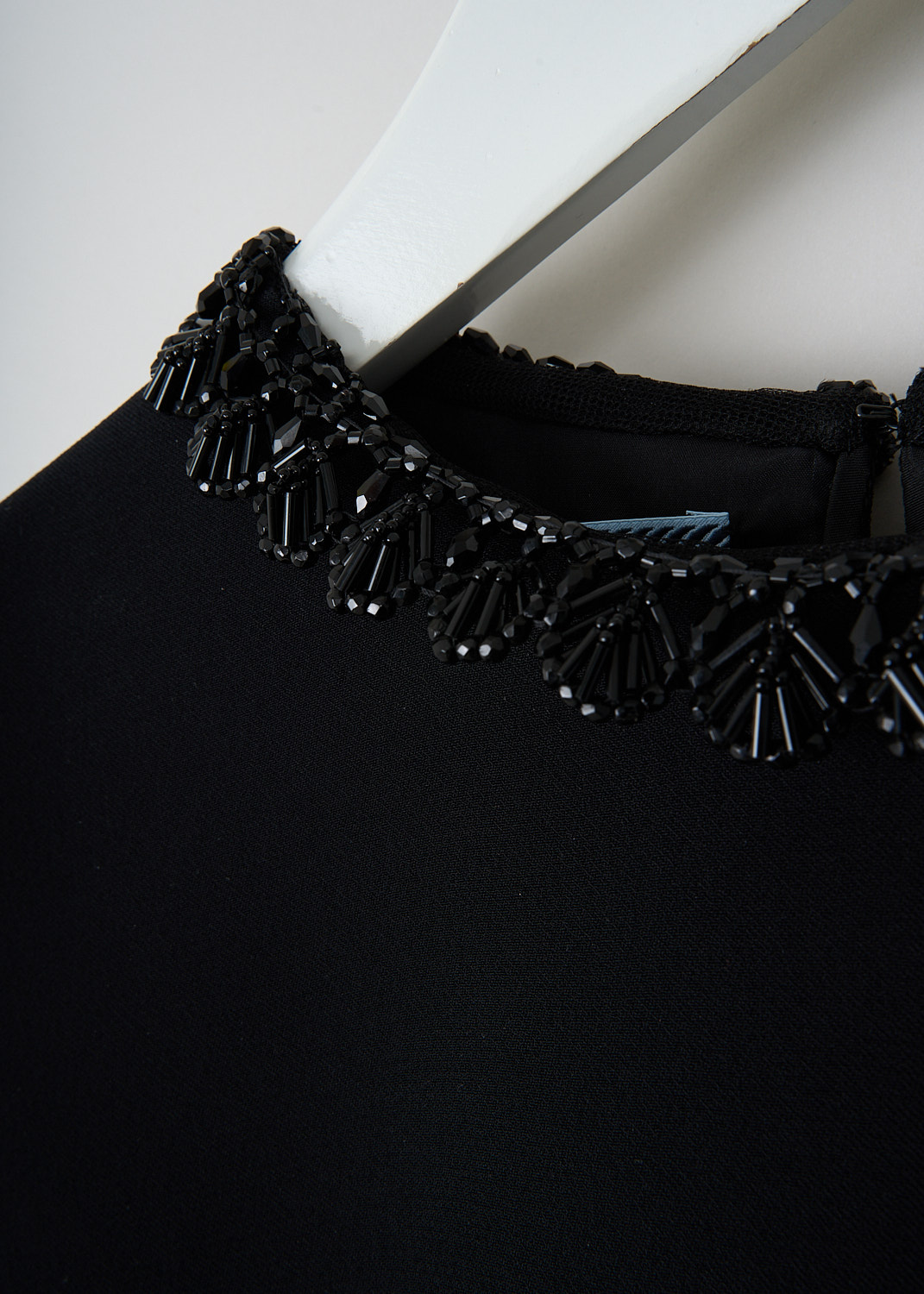 Prada, Black crepe sleeveless dress, 1M2N_CADY_RIC_CROCHE_P34I7R_F0806_NERO_NERO, Black, Detail, This black crepe sleeveless dress has a round bead-embellished neckline and a matching bead-embellished hem. In the back, a concealed centre zip functions as the closure. 


