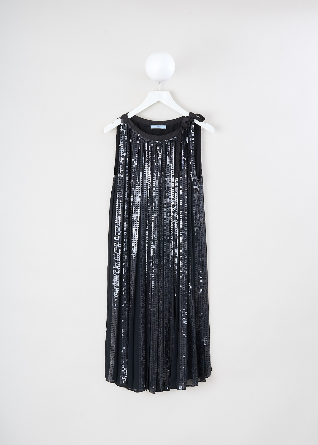 Prada, Black pleated sequin dress with bow, 1M4T_CHIFFON_PAILLET_P34L7R_F0002_NERO, Black, Front, This black sleeveless dress gas a boat neckline with, to one side, a bow-tie. The pleated chiffon dress is fully embellished with sequin. A concealed side zip functions as the closure. 
