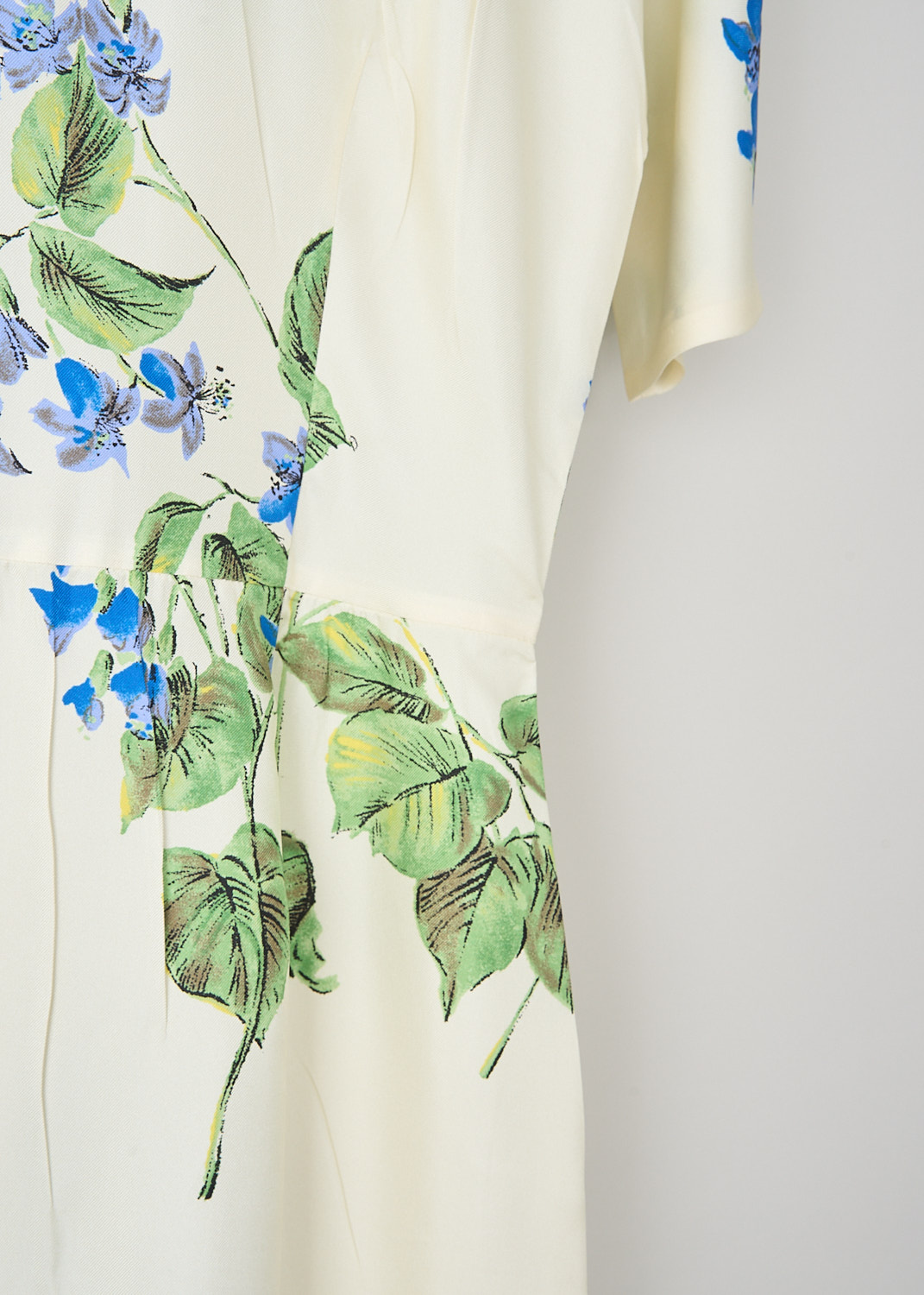 Prada, Off-white Viola midi dress, 14NZ_TWILL_VIOLA_P3L96R_F0K74_TALCO, White, Blue, Print, Detail, This off-white midi dress has a an all-over blue-and-green Viola print with crinkled finish. The dress has a high neckline and short sleeves. The waist is cinched with dart detailing. In the front, along the straight hem, the brand's logo has been embroidered.  In the back, a concealed clasp-and-zip function as the closure. The dress comes with a slip dress.
