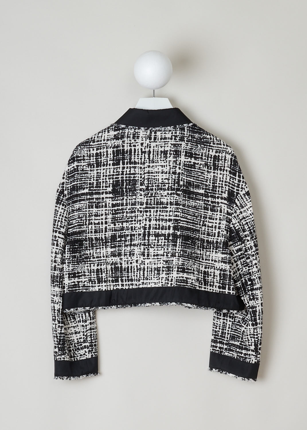 PRADA, BLACK AND WHITE TWEED CROPPED JACKET, P520M_F0A72_TELONE_TWEED_RE_AVORIOA_NERO, Black, White, Print, Back, This black and white tweed jacket has a cropped length and features a classic collar in black and a front zip closure. The jacket has a broad trim black along the two welt pockets, the cuffs and the hemline. In the front, a black and silver logo plaque can be found.
