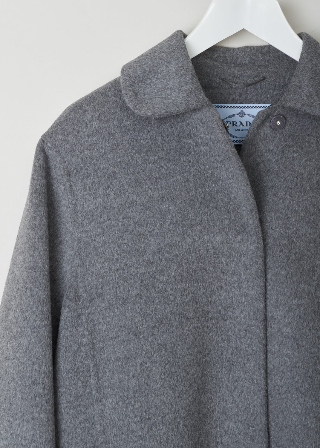 PRADA, GREY WOOL COAT WITH CLAUDINE COLLAR, P650E_03H_Cashgora_Double_F0031_Grigio, Grey, Detail, This grey wool-blend coat has a Claudine collar and a concealed press-button closure. Concealed slanted pockets can also be found on the front of the coat. In the back, the coat has a pleated yoke and a martingale.
