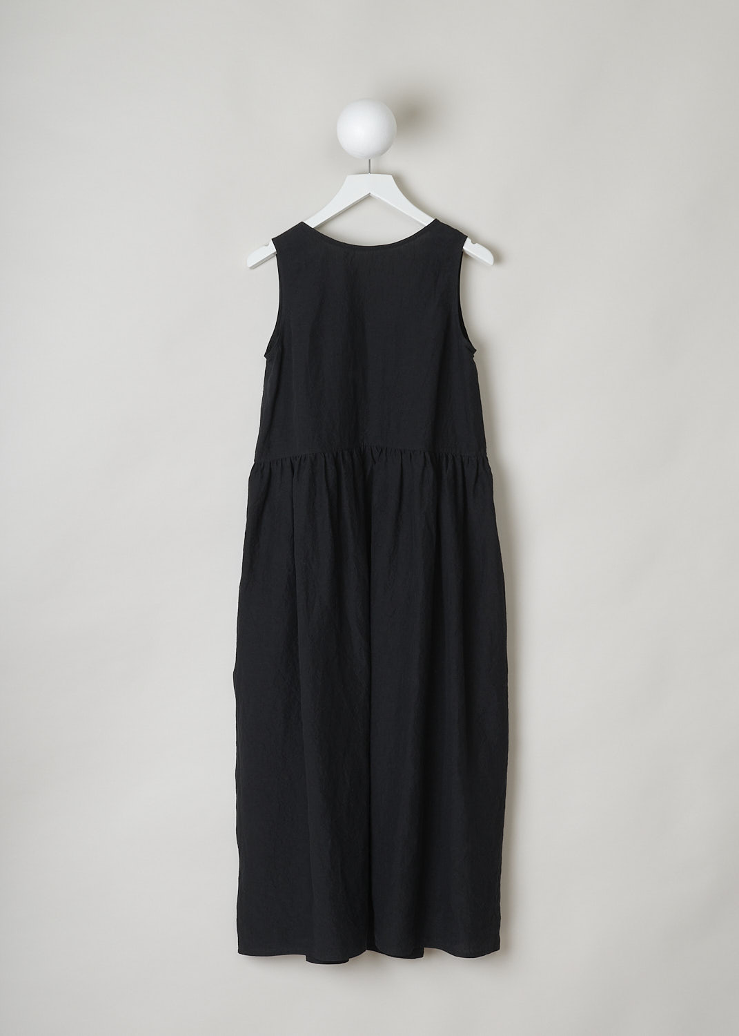 SOFIE Dâ€™HOORE, BLACK LINEN DANDLE DRESS, DANDLE_LIFE_BLACK, Black, Back, This black sleeveless dress has U-neckline. The dress has a wide A-line silhouette. A straight crystal pleated hemline separates the bodice from the midi length skirt. Concealed slanted pockets can be found in the side seam. 
