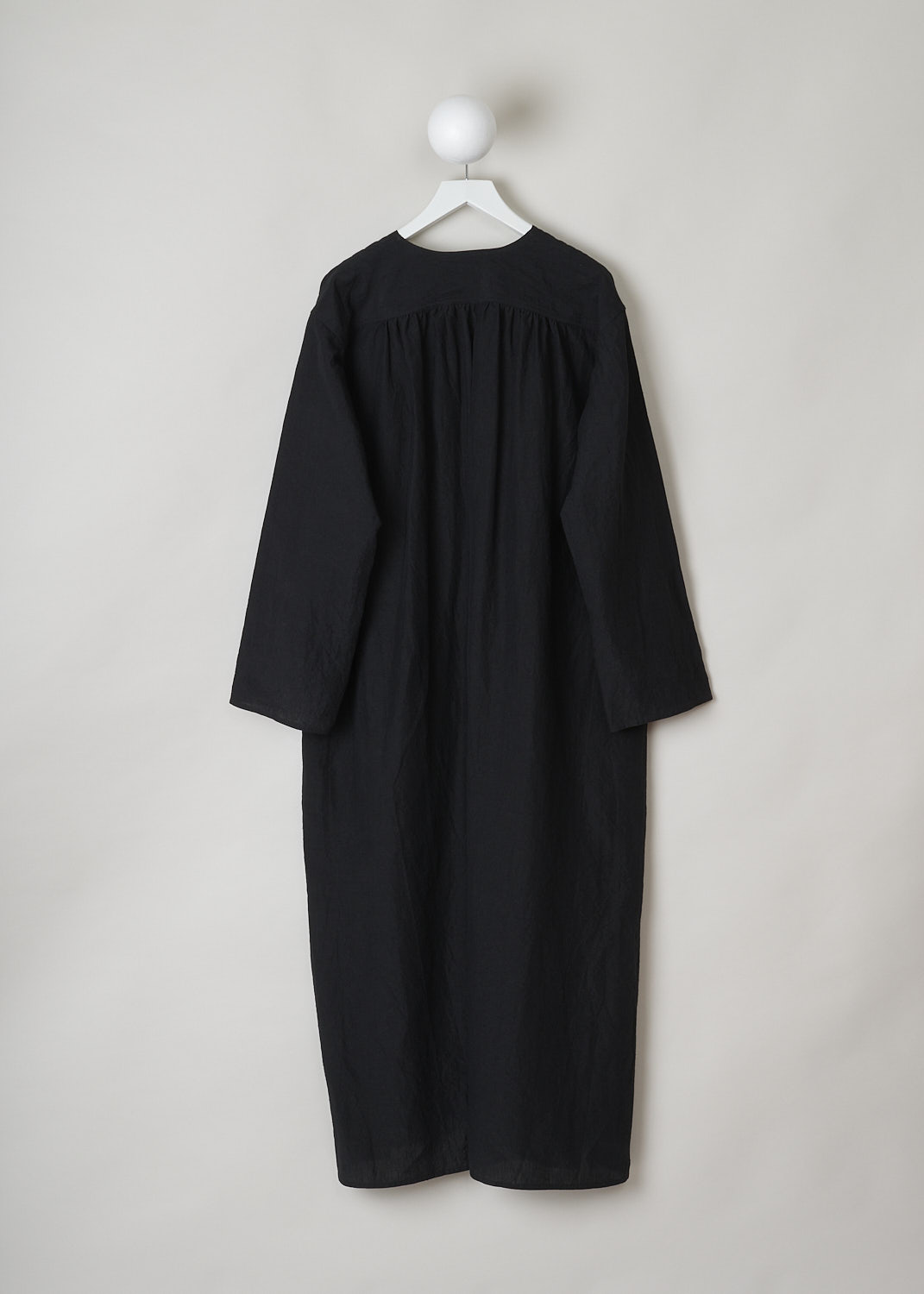 SOFIE Dâ€™HOORE, BLACK LINEN DELIZA DRESS, DELIZA_LIFE_BLACK, Black, Back,This black linen dress has a round neckline that goes into a deep V cutout. Subtle ruching can be found beneath the V. This long sleeve midi dress has a straight hemline with an asymmetrical finish, meaning the back is a little longer than the front. The dress has concealed slanted pockets and slits can be found on either side. The dress has a wide silhouette. 
