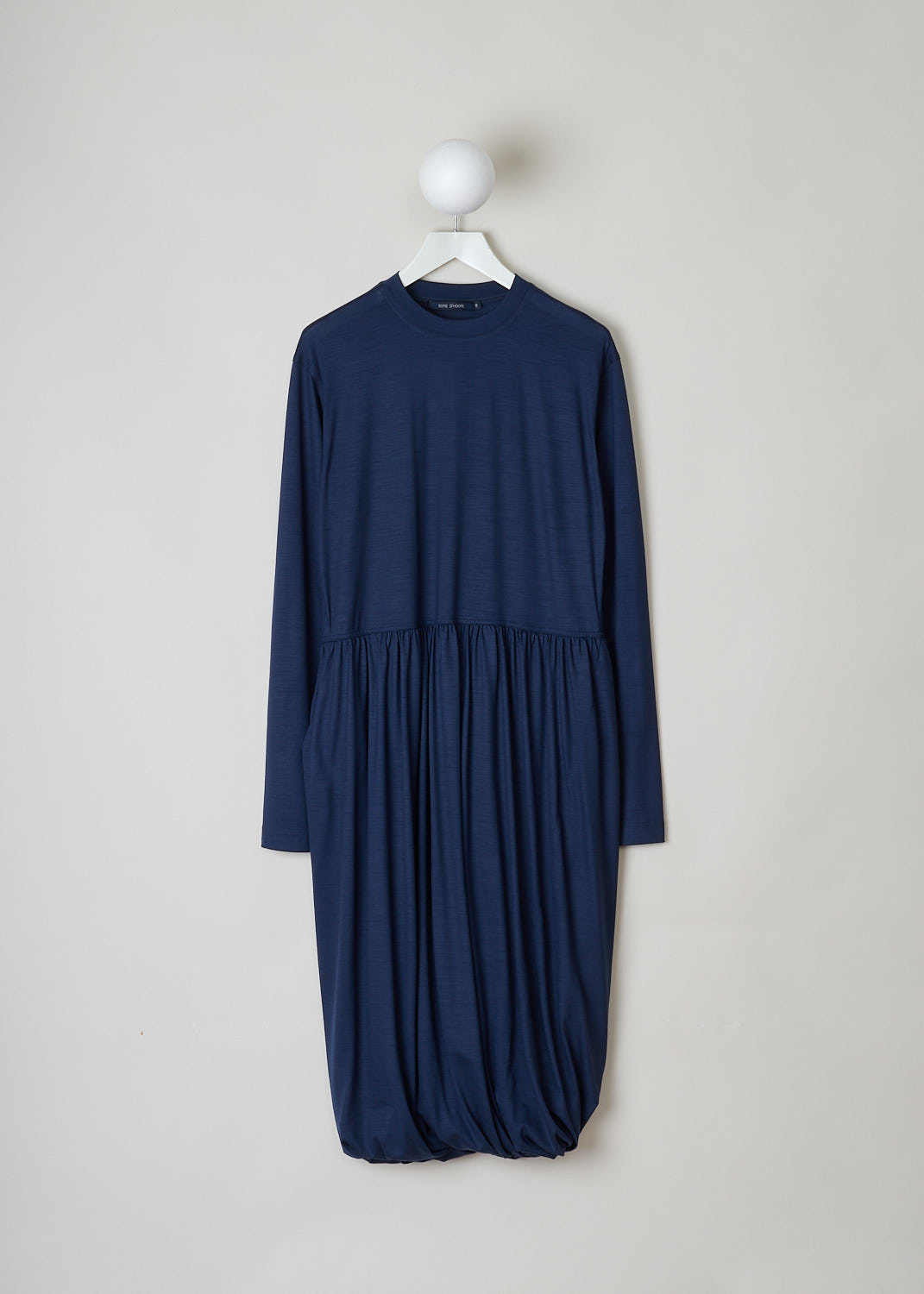 SOFIE Dâ€™HOORE, NAVY BLUE LONG SLEEVE DRESS, DEMURE_WOJE_NAVY, Blue, Front, This navy blue mid-length dress features a round neckline, a plain long sleeve bodice and a twisted balloon skirt. A single side pocket can be found concealed in the seam. 
