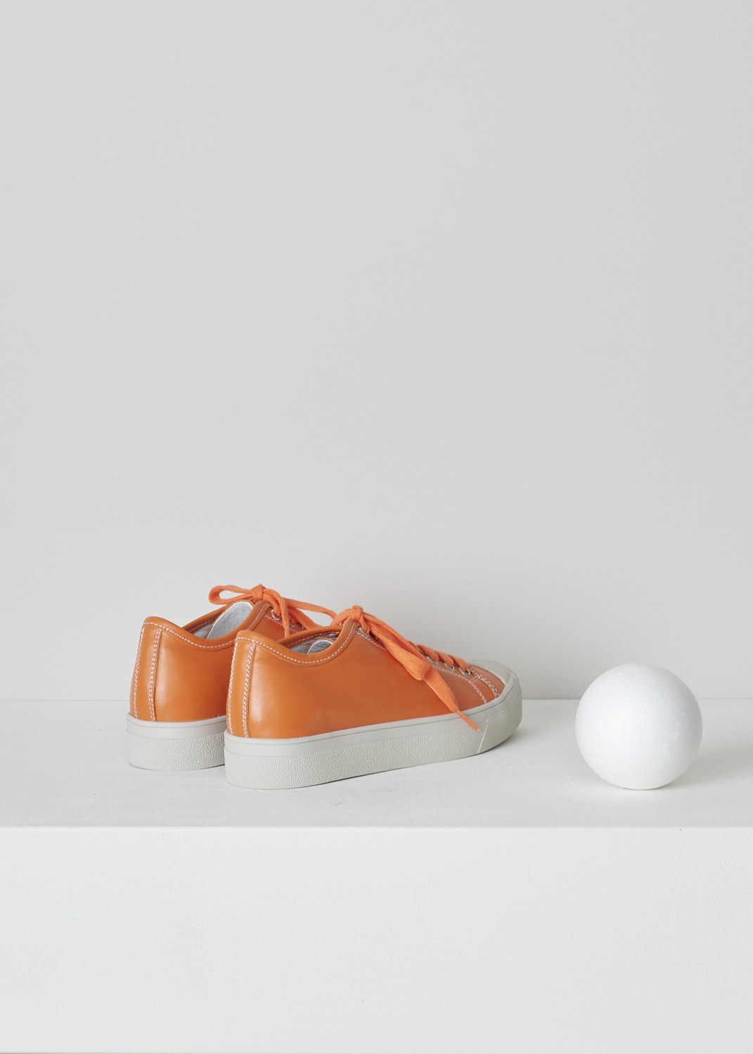 SOFIE Dâ€™HOORE, ORANGE LEATHER SHOES, FOLK_LMAST_LMAST_ORANGE, Orange, Back, These orange leather sneakers feature a front lace-up closure with orange laces. These sneakers have a round toe with a white rubber toe cap that goes down into the white rubber sole. Contrasting white stitching is used throughout. The sneakers come with an additional pair of white laces.
