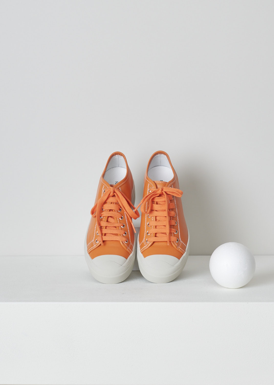 SOFIE Dâ€™HOORE, ORANGE LEATHER SHOES, FOLK_LMAST_LMAST_ORANGE, Orange, Top, These orange leather sneakers feature a front lace-up closure with orange laces. These sneakers have a round toe with a white rubber toe cap that goes down into the white rubber sole. Contrasting white stitching is used throughout. The sneakers come with an additional pair of white laces.
