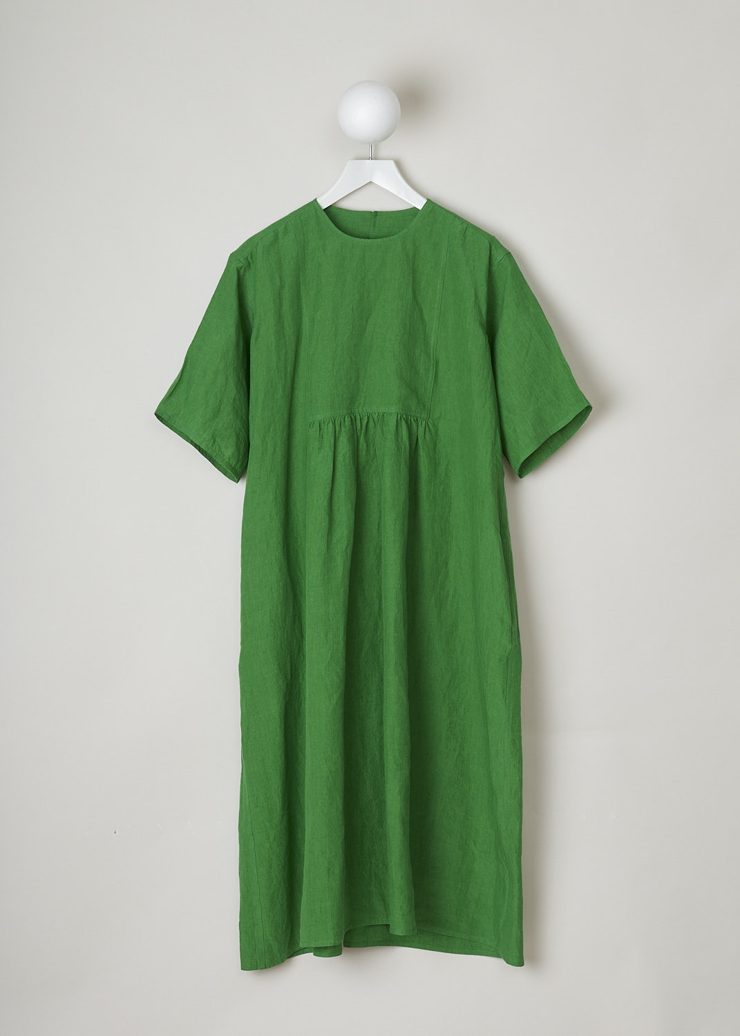 SOFIE Dâ€™HOORE, BRIGHT GREEN LINEN DARNELLE DRESS, DARNELLE_LIFE_GRASS, Green, Top, This oversized green midi dress features a round neckline, dropped shoulders and short sleeves. The A-line dress has a square bib-like front with pleated details below. Concealed in the side seams, slanted pockets can be found. The dress has a straight hemline with slits on either side. 

