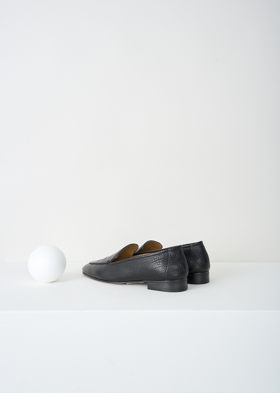 The Row, Adam loafers in Black, ADAM_F1017_BFG15_BLACK, 
Black, Back, These black grained leather Adam loafers have a round toe. Throughout, these loafers have a black piped trim. These loafers have a small stacked heel. 