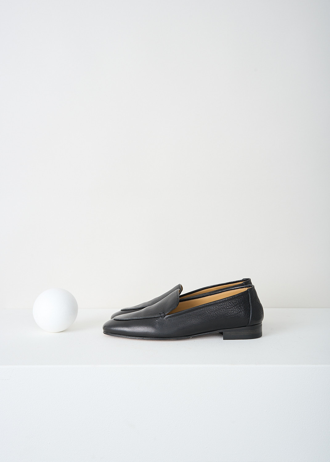 The Row, Adam loafers in Black, ADAM_F1017_BFG15_BLACK, 
Black, Side, These black grained leather Adam loafers have a round toe. Throughout, these loafers have a black piped trim. These loafers have a small stacked heel. 