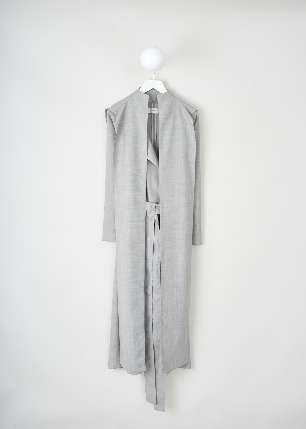 The Row, Badva coat in Grey Melange, BADVA_COAT_6903_W2453_GREY_MELANGE, Grey, Front, This Badva coat in Grey Melange has a detachable hood with long panels. Beneath the panels, the coat has a notched lapel. Around the waist, a matching fabric belt can be used to cinch in the waist. The coat is designed for a loose fit.
