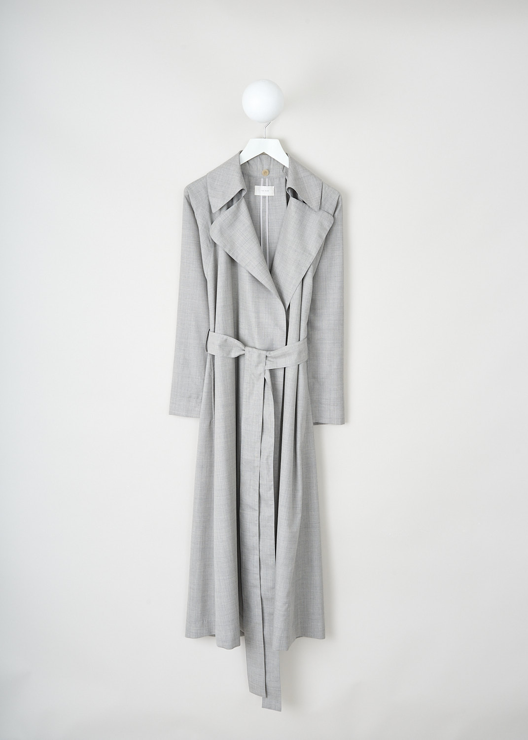 The Row, Badva coat in Grey Melange, BADVA_COAT_6903_W2453_GREY_MELANGE, Grey, Front 1, This Badva coat in Grey Melange has a detachable hood with long panels. Beneath the panels, the coat has a notched lapel. Around the waist, a matching fabric belt can be used to cinch in the waist. The coat is designed for a loose fit.

