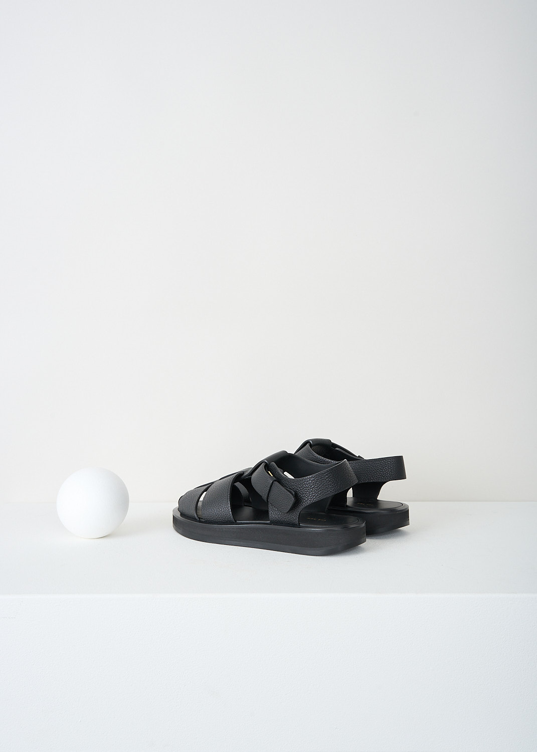 The Row, Fisherman sandal in black, FISHERMAN_FLAT_SANDAL_F1203_L129_BLACK, Black, Back, These Fisherman crepe sandals in black grained leather have an adjustable ankle strap. These sandals have a round toe with woven cage straps across the vamp. 

