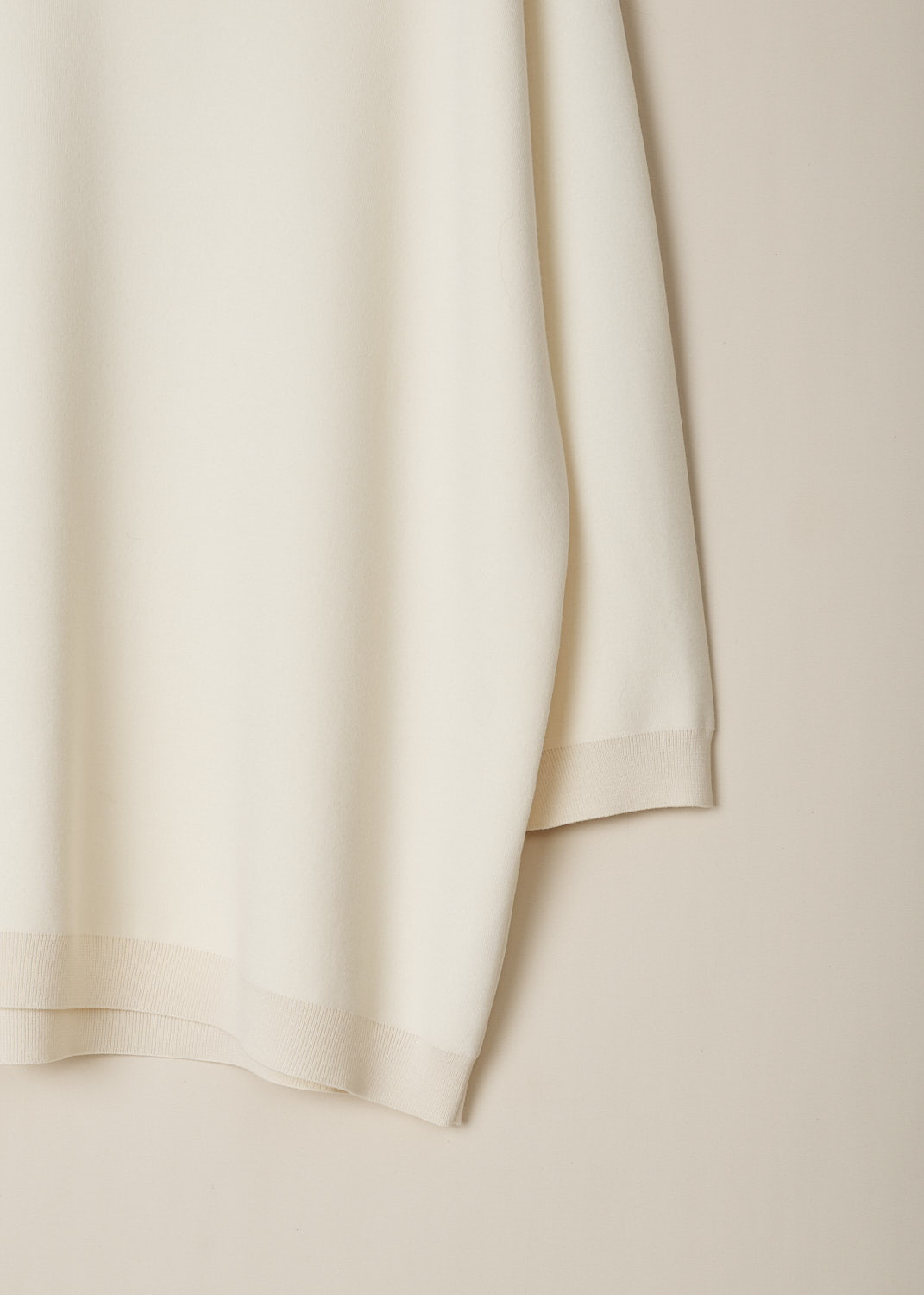 THE ROW, IVORY WHITE OVERSIZED MIRU TOP, MIRU_TOP_3227FI_BQ_IVORY, White, Detail, This ivory white oversized Miru top has a deep V-neckline. The long sleeves have dropped shoulders and ribbed cuffs. The top has a straight, ribbed hemline. 
