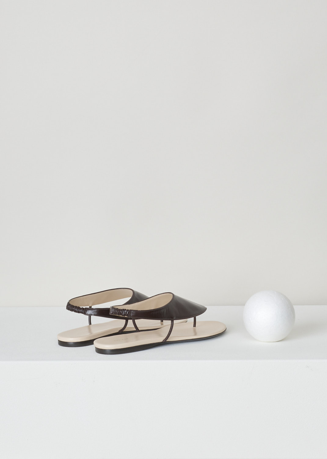 The Row, Dark brown ravello thong sandal, F1155_L35_DBR, brown, back, Ravelo slip-on sandals from The Row. Coloured to a lovely shade of dark brown. Featuring a round and open toe vamp and comes with an elastic slingback strap. 