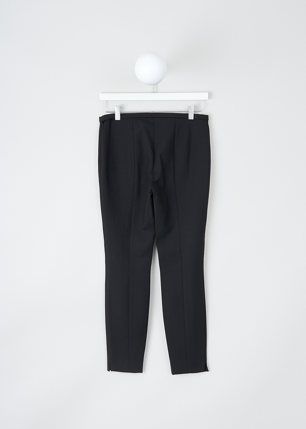 The Row, Sovino pants in black, SOVINO_PANT_5922W2119_BLACK, Black, Back, These Sovino pants in black have a narrow waistband with a side zip closure. These pants have skinny pant legs with pressed creases. The hem has small side slits. 


