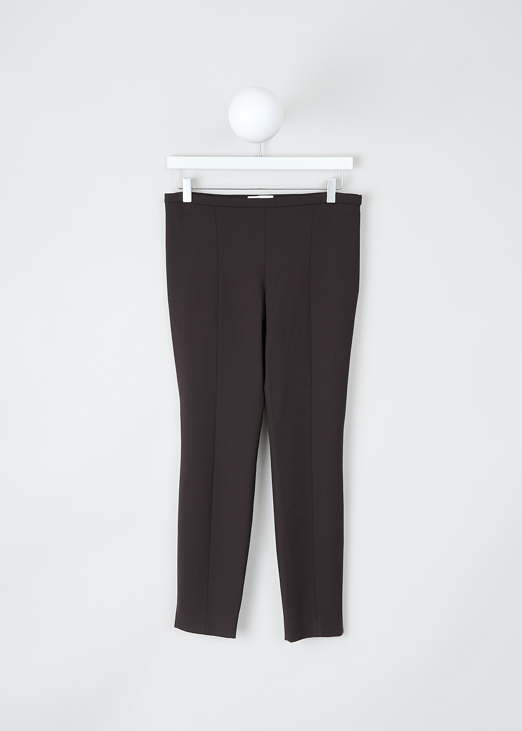 The Row, Sovino pants in Saddle Brown, SOVINO_PANT_5922W2119_SADDLE_BROWN, Brown, Front, These Sovino pants in Saddle Brown have a narrow waistband with a side zip closure. These pants have skinny pant legs with pressed creases. The hem has small side slits. 