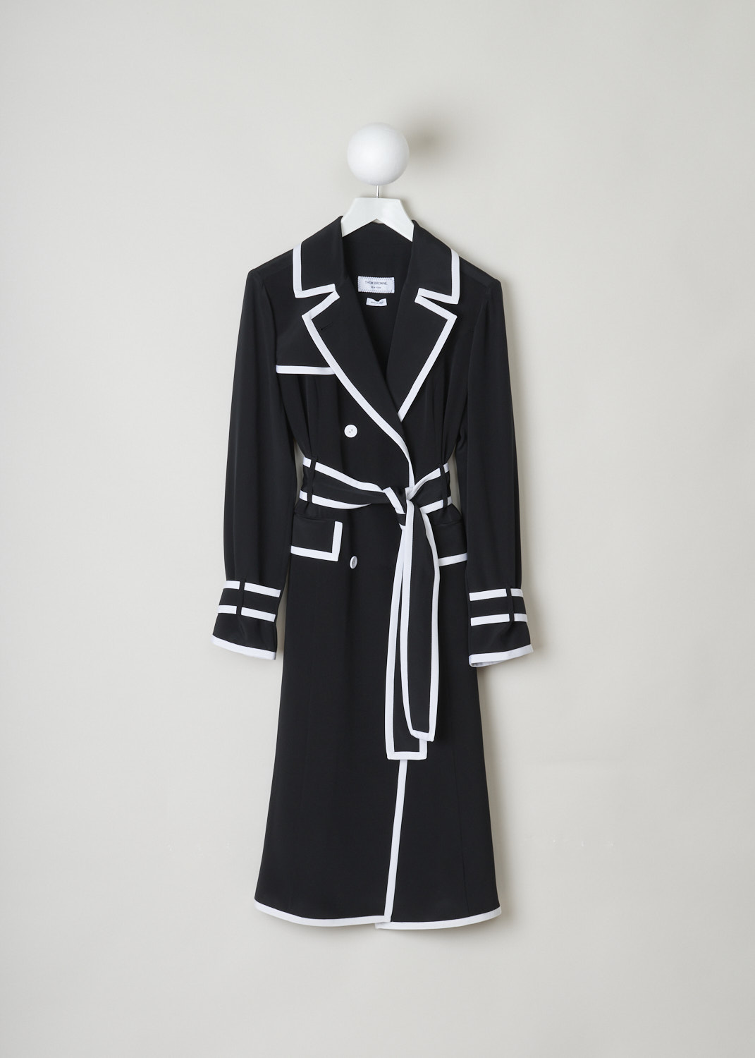 Thom Browne, Black trench neckline dress with contrasting white trim, FDSB70B_06391_001, Black, Front, Black dress with white contrasting trim reminiscent of a trench coat. Double breasted buttons decorate the front of the dress, as do the two pockets. Further adorning the front is a storm guard which wraps around to the back. The dress has long sleeves with belted cuffs. The dress comes with a built-in belt around the waist. The signature Grosgrain loop tab can be found on the back of the collar. 