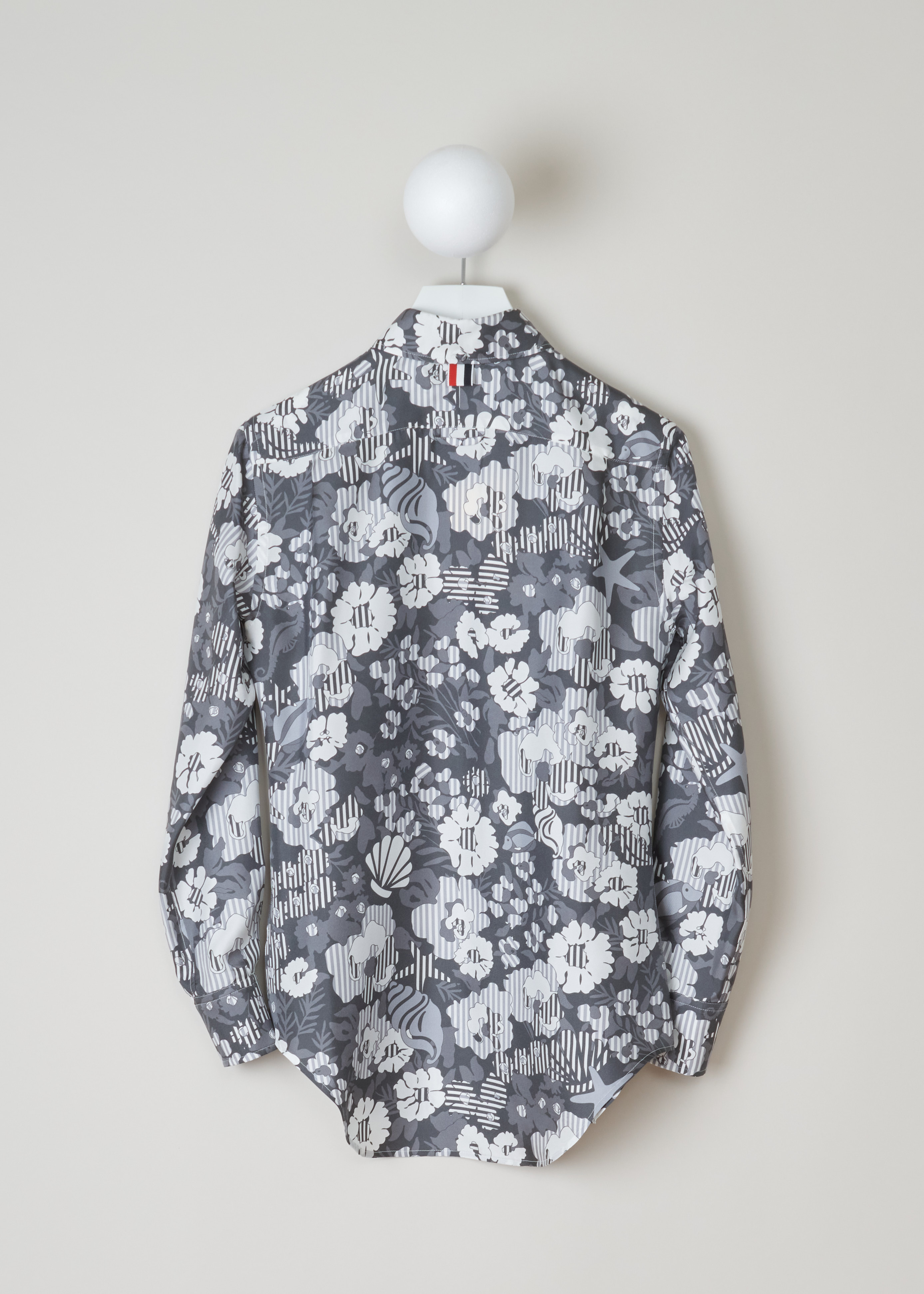Thom Browne Sunny floral print shirt FLL005A_06160_035_Med_Grey back. Long sleeved shirt in the sunny floral pattern with a pointed, buttoned collar, a chest pocket, an exterior name tag, buttoned cuffs and a rounded hem.