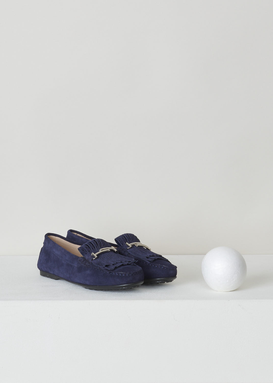 TODS, BLUE SUEDE MOCASSINS WITH BUCKLE, XXW0LU0Y470RE0U824, Blue, Front, Blue suede loafers with a rounded toe. These shoes feature fringed tassels and a silver-toned buckle. Noticeable are the rubber soles with studded profile that extends further to the rear trim.
