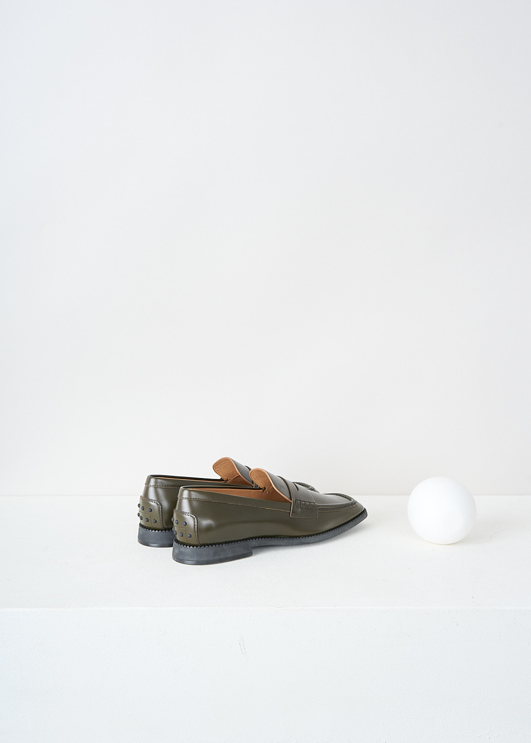 Tod's, Army green penny loafers, XXW44K0GG20_SOO_V611, Green, Back, These army green slip-on penny loafers have a squared-off toe and a decorative slotted leather strip over the topside. These loafers have black soles.

