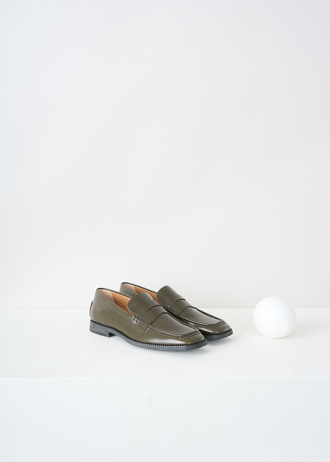 Tod's, Army green penny loafers, XXW44K0GG20_SOO_V611, Green, Front, These army green slip-on penny loafers have a squared-off toe and a decorative slotted leather strip over the topside. These loafers have black soles.

