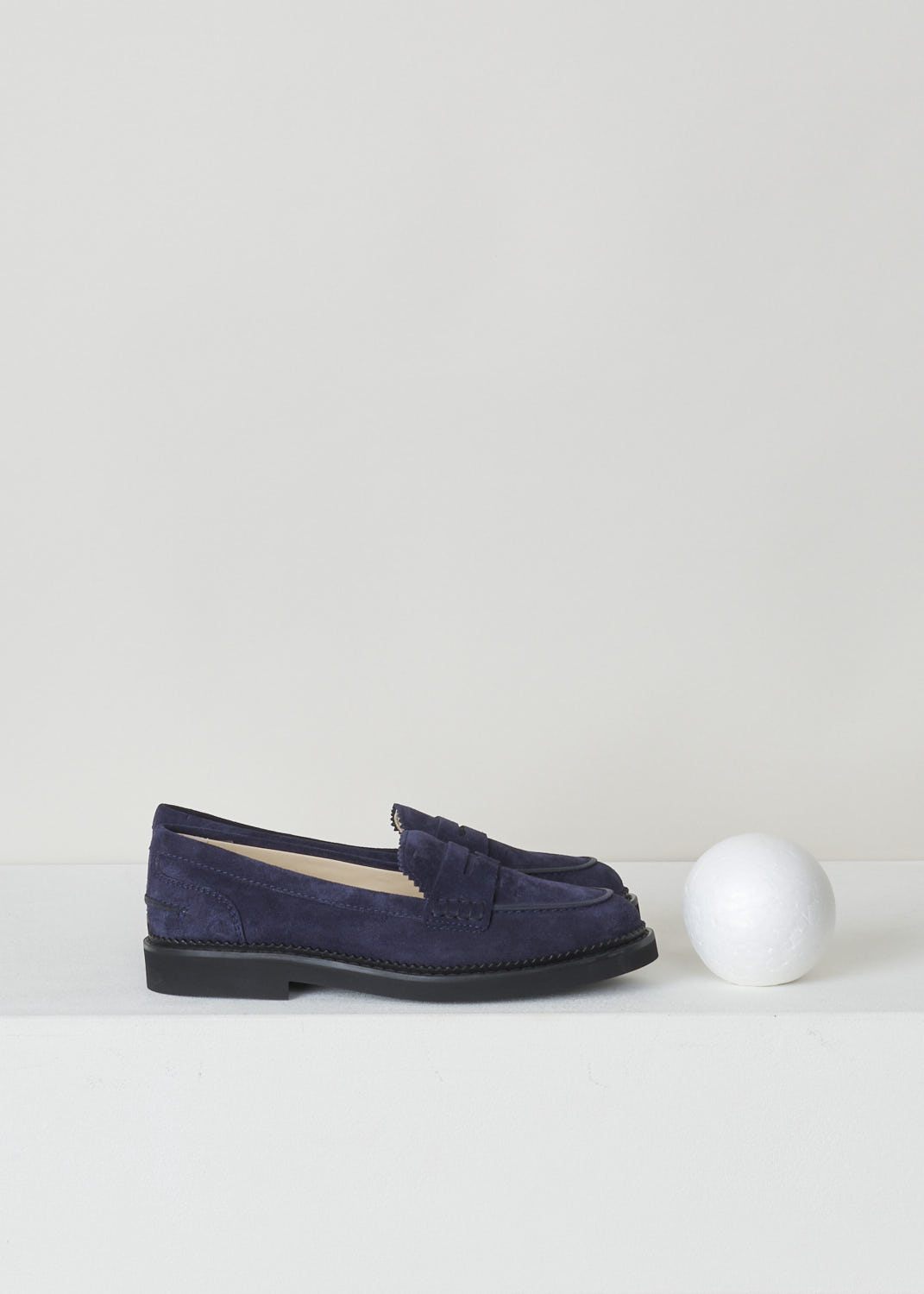 TODS, BLUE SUEDE PENNY LOAFERS, XXW76B0BP10RE0U824, Blue, Side, These blue suede slip-on penny loafers have a rounded toe and a decorative slotted leather strip over the upper side. The upper side being decorated with serrated edges. These loafers have black soles. 
