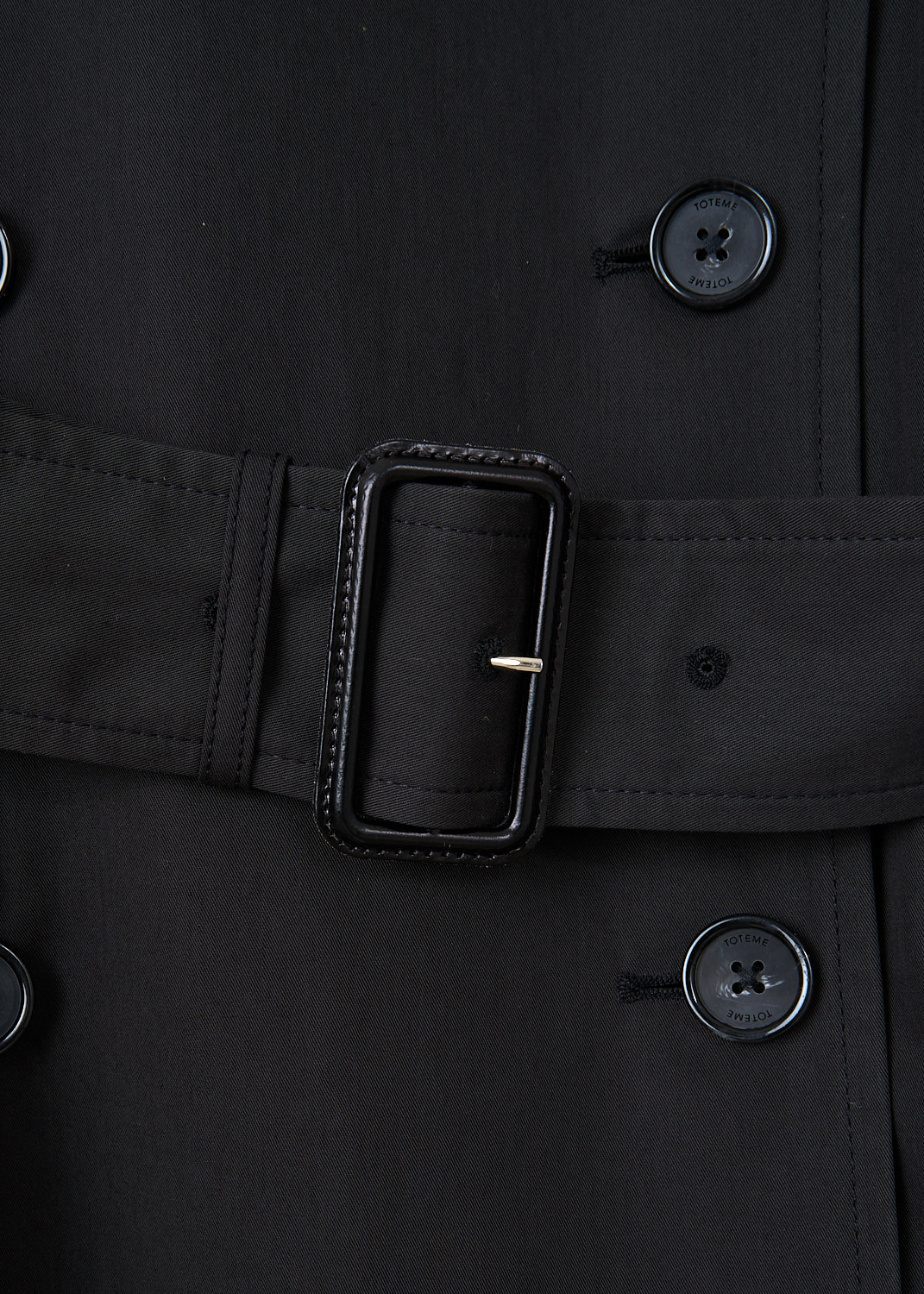 Close-up of the Toteme trench coat showcasing the oversized lapels, double-breasted button closure and tonal belt detailing – luxury designer item at Kiki’s Stocksale.