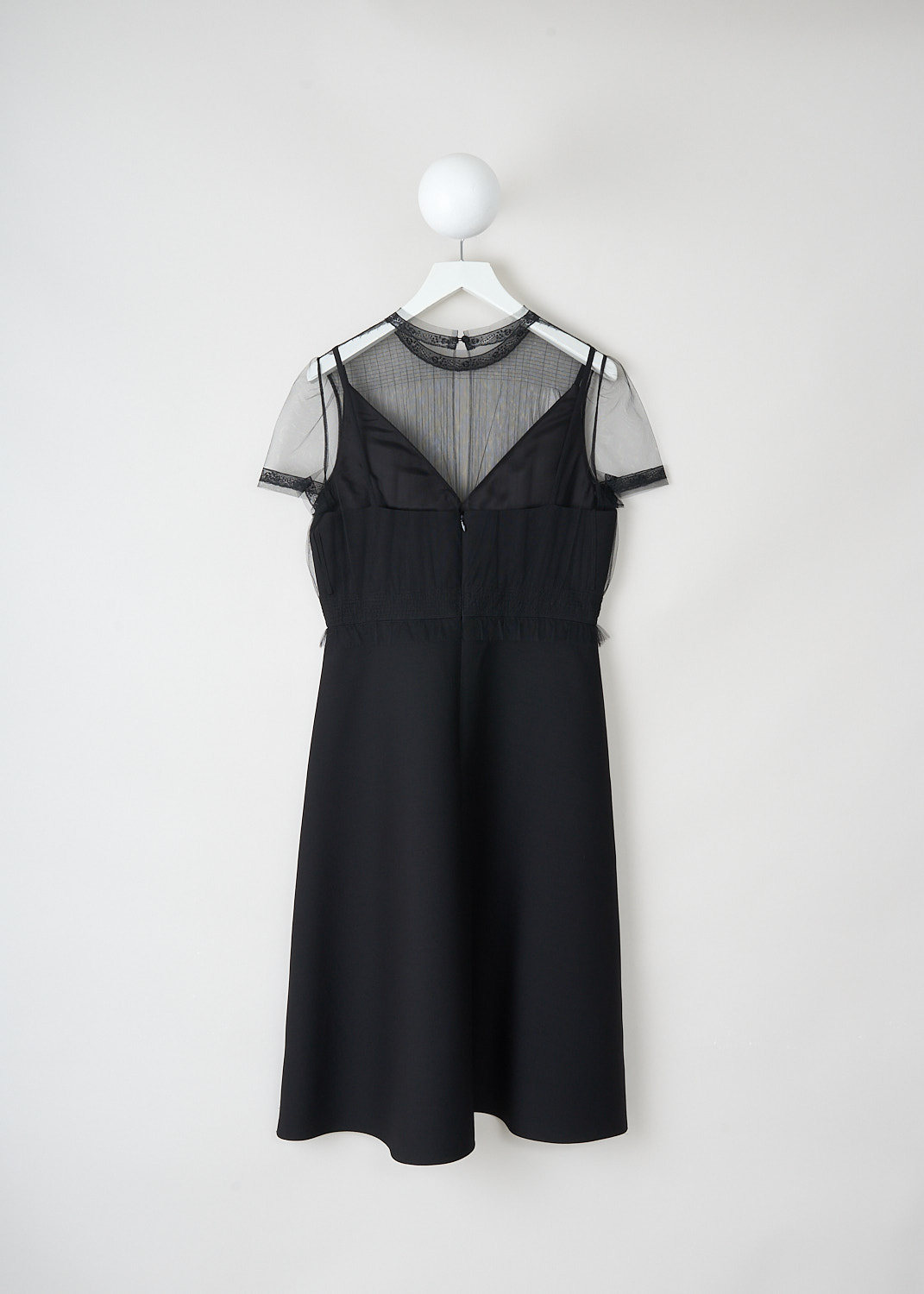 Back view of Valentino black midi dress with buttoned mesh overlay closure and concealed centre back zip, A-line skirt, available at Kiki’s Stocksale Maastricht designer boutique