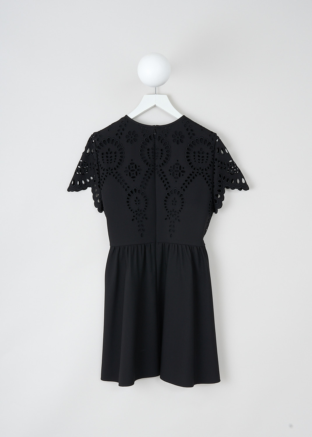 Valentino, Black broderie anglaise mini dress, WB3VAWF06GR_0NO, Black, Back, This black broderie anglaise mini dress has a short-sleeve bodice with a round neckline and a flares skirt with slanted pockets. The dress is fully lined. In the back, a concealed centre zip functions as the closure.
