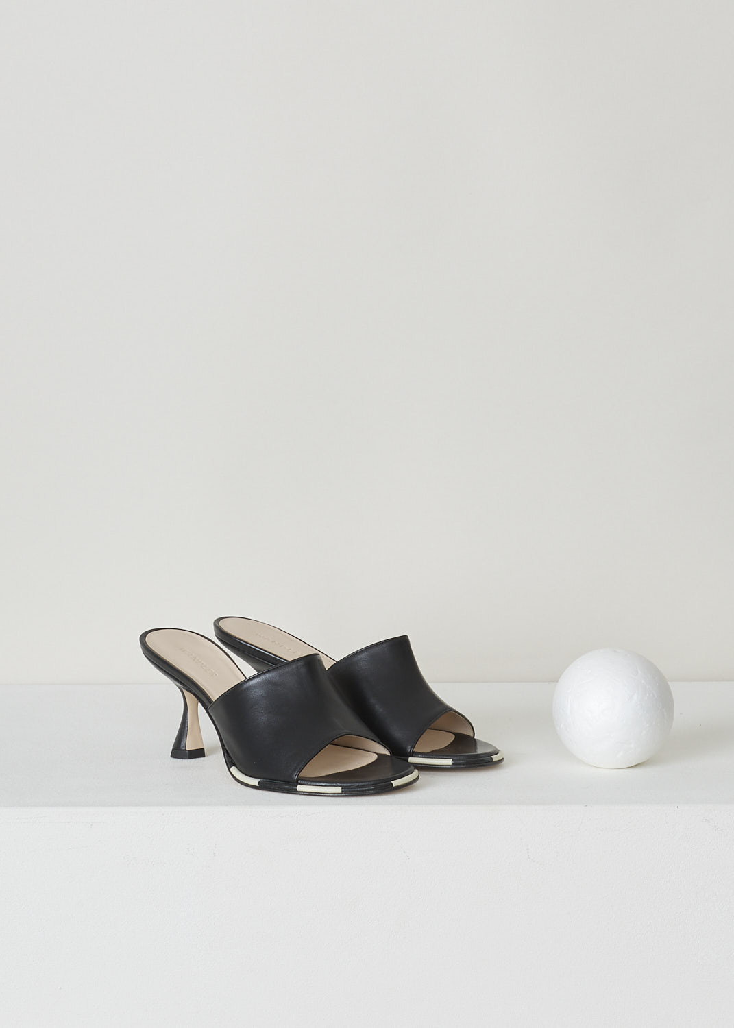 WANDLER, BLACK HEELED MULES, 22202_701204_3248_AGNES_MULE_BLACK_MIX, Black, Front, These black heeled mules have a rounded open-toe with contrasting white stripes decorating the trim. The slip-on mules have a mid-height trapezoid shaped heel.
