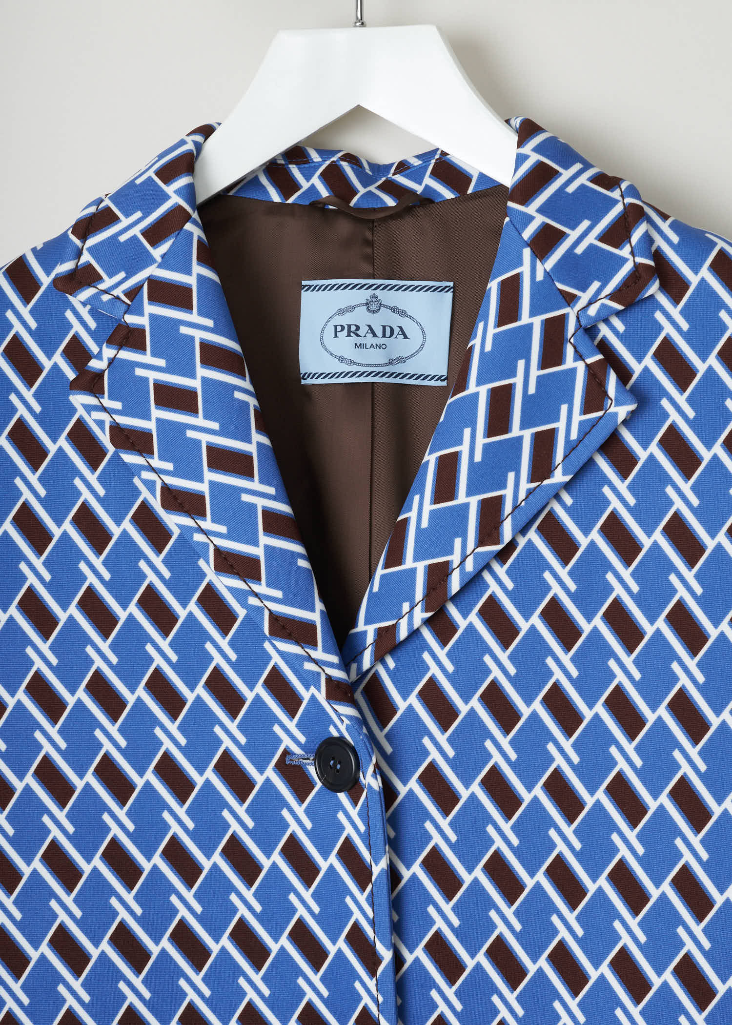 Prada tecno jersey argyle Tecno_Jersey_AR_P690II_F0237_Pervinca pervinca detail. Geometric illusion-print coat in blue and brown from argyle printed techno jersey with button front fastening, flap pockets and belted cuffs.
